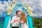 The happy bride and groom with white doves on a tropical beach u