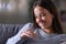 Happy bride looking at engagement ring at home