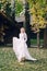 Happy bride is posing in fluttering dress on nature. Artwork