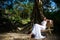 Happy bride sits on a bench in the park