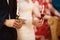 Happy bride and stylish groom holding candles wedding ceremony, wedding couple at matrimony in church, emotional moment, religion