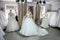 Happy bride tries on a wedding dress in salon