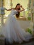 Happy bride before wedding. Beautiful wedding dresses in boutique. Wonderful bridal gown. woman is preparing for wedding