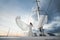 Happy bride on a yacht. White yacht with sail set goes along the island.