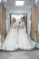 Happy brides in wedding dresses posing in salon