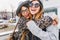 Happy brightful positive moments of two stylish girls hugging on street in city. Closeup portrait funny joyful