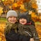 Happy brothers boys 9 years old and baby 6 months old. Little boys smiling on autum fall leaves background