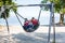 Happy brothers, children on the beach, swinging in a big round swing