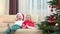 Happy brothers embrace smiling laughing close Christmas tree, Santa costume
