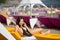 Happy brunette female with a perfect body in a black swimsuit lying on a yellow lounger on the luxury resort
