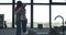 Happy brunette woman hugging lesbian redhead friend in front of window at home. Portrait of loving Caucasian homosexual