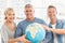 Happy business colleagues holding terrestrial globe