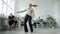 Happy business lady dancing in office celebrating success while staff clapping hands sitting at desks