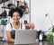 Happy business owner standing at counter