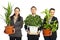 Happy business people holding vases with plants