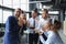 Happy business team with birthday cake are greeting colleague at office party