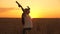 Happy business woman shakes hands, enjoys good harvest in wheat field. Farmer woman with tablet works in a wheat field