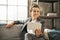 Happy business woman sitting on divan in loft