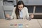 Happy business woman spreads money on a desk