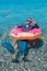 Happy businessman in flippers on an inflatable donut in the sea. Summer vacation concept