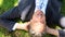 Happy businessman lying on the grass