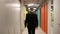 Happy businessman manager walking and dancing in office corridor, back view.