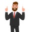 Happy businessman pointing up index fingers gesture to copy space. Man showing joyful success hand gesture to upward.