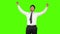 Happy businessman showing thumbs up on green background