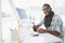 Happy businessman using digitizer at desk