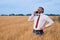 happy businessman in wheat field emotionally talking on the phone