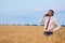 happy businessman in wheat field emotionally talking on the phone