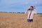 happy businessman in wheat field emotionally talking on the phone