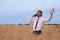 happy businessman in wheat field emotionally talking on the phone