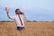 happy businessman in wheat field emotionally talking on the phone