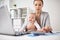 Happy businesswoman with baby and laptop at office