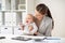 Happy businesswoman with baby working at office