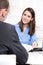 Happy businesswoman in a blue blouse in interview or meeting