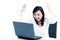 Happy businesswoman cheering in front of laptop