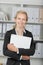 Happy Businesswoman Holding Binder