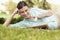 Happy Businesswoman With Newspaper Holding Spectacles While Lying On Grass