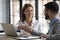 Happy businesswoman shaking hands with man job seeker near laptop.