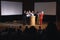 Happy businesswoman standing at the stage of the auditorium with colleagues