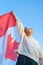 The happy Canadian celebrates and rejoices in success and victory. A resident of Canada. Woman with national flag
