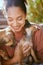 Happy, care and girl playing with dogs at animal adoption center with excited smile holding puppy. Happiness, black