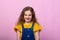 Happy carefree child emotions. Energetic joyful adorable girl laughing at joke on pink background