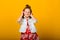 Happy carefree child emotions. Energetic joyful adorable little girl with headphones laughing at joke on yellow background