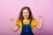 Happy carefree child emotions. Energetic joyful adorable little girl laughing at joke on pink background
