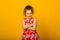 Happy carefree child emotions. Energetic joyful adorable little girl laughing at joke on yellow background