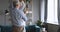 Happy carefree elderly senior grandparents dancing waltz in living room