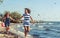 Happy carefree family running on beach at sea.